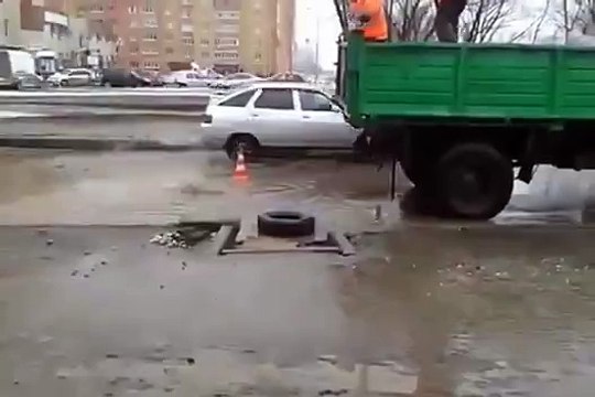 Workers Try to Fix Flooded Road