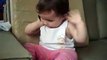 A cute baby talking on mobile phone