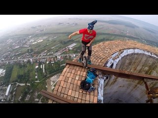 Daredevil Unicyclist Performs on Top of Giant Chimney