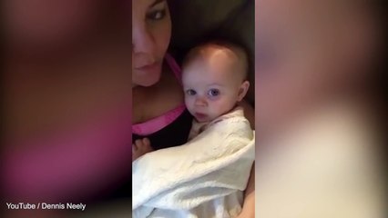 Cute fifteen month old baby imitates her mum