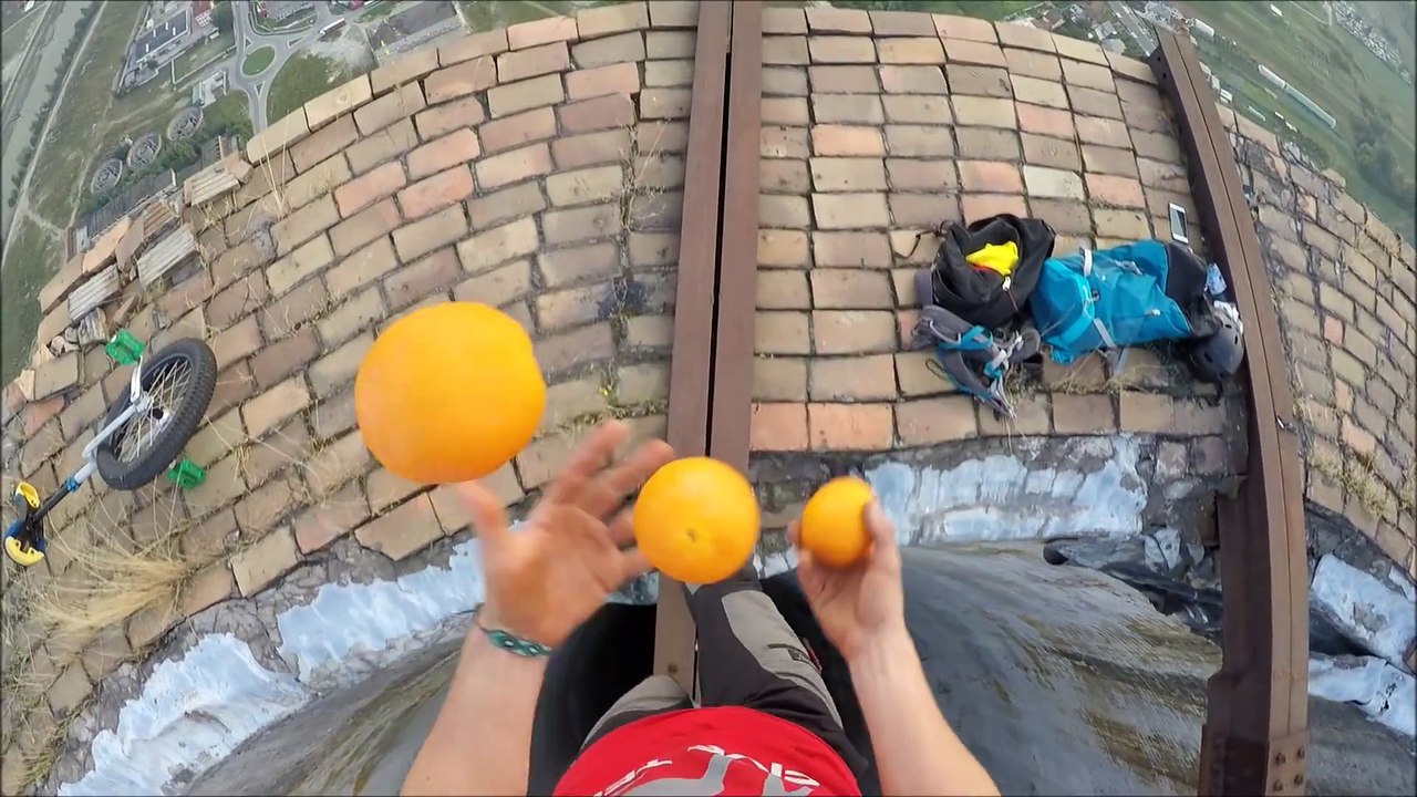 Stuntman rides unicycle on massive chimney in Romania