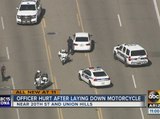 Officer hurt after laying down motorcycle