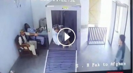 Man go from machine when  security man checking his bag