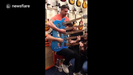 Three men perform on five-necked electric guitar