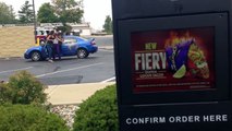 Guy calmly orders food at Taco Bell drive thru while filming 2 girls fighting