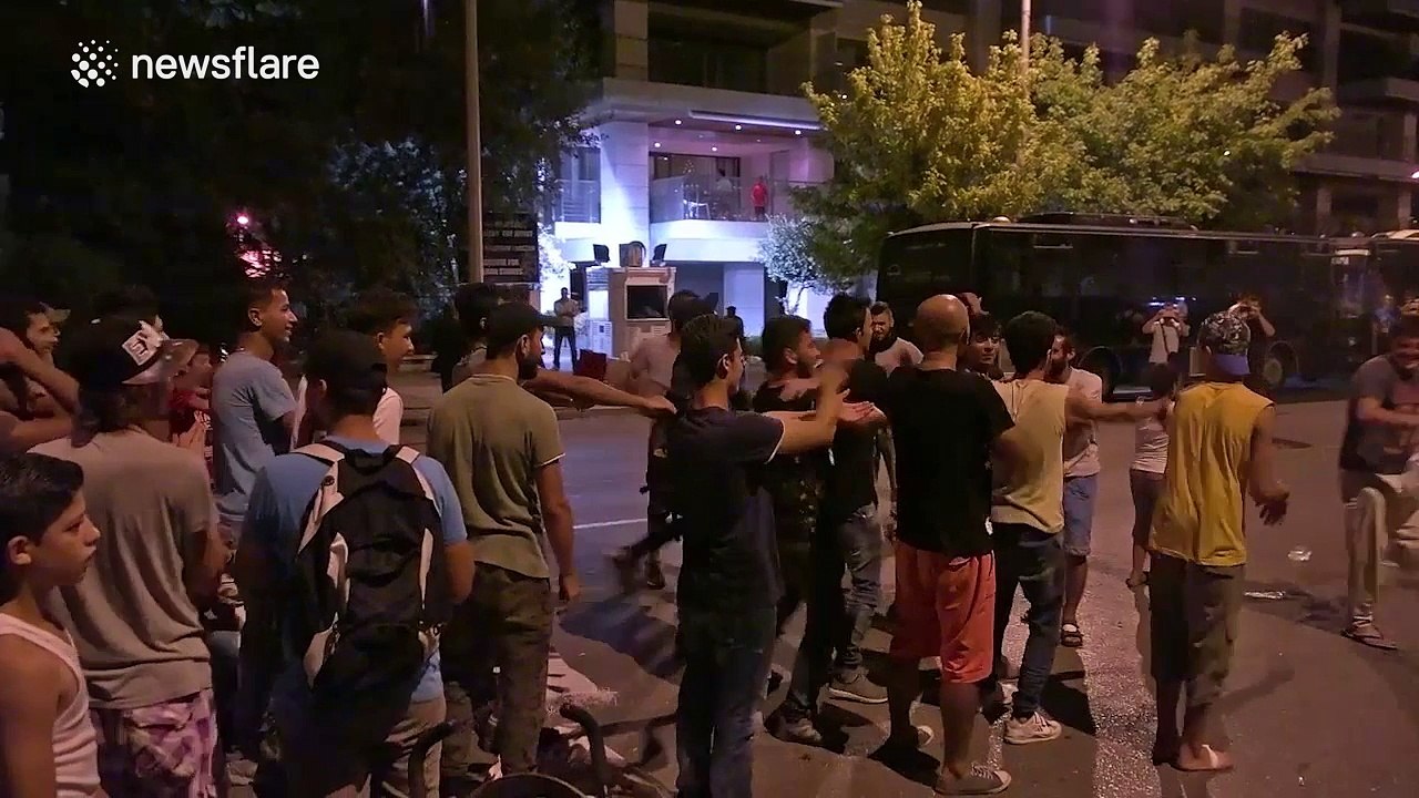 Refugees dance during protest at German Consulate in Thessaloniki