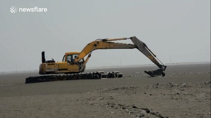 Police officers rescue elderly man trapped in wet sand