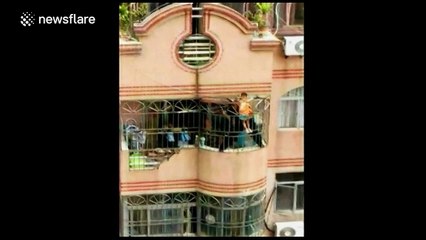 Firefighters rescue boy stuck in security net on seventh floor