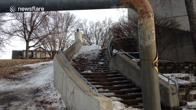 Man attempts to grind handrail on skis, hurts himself