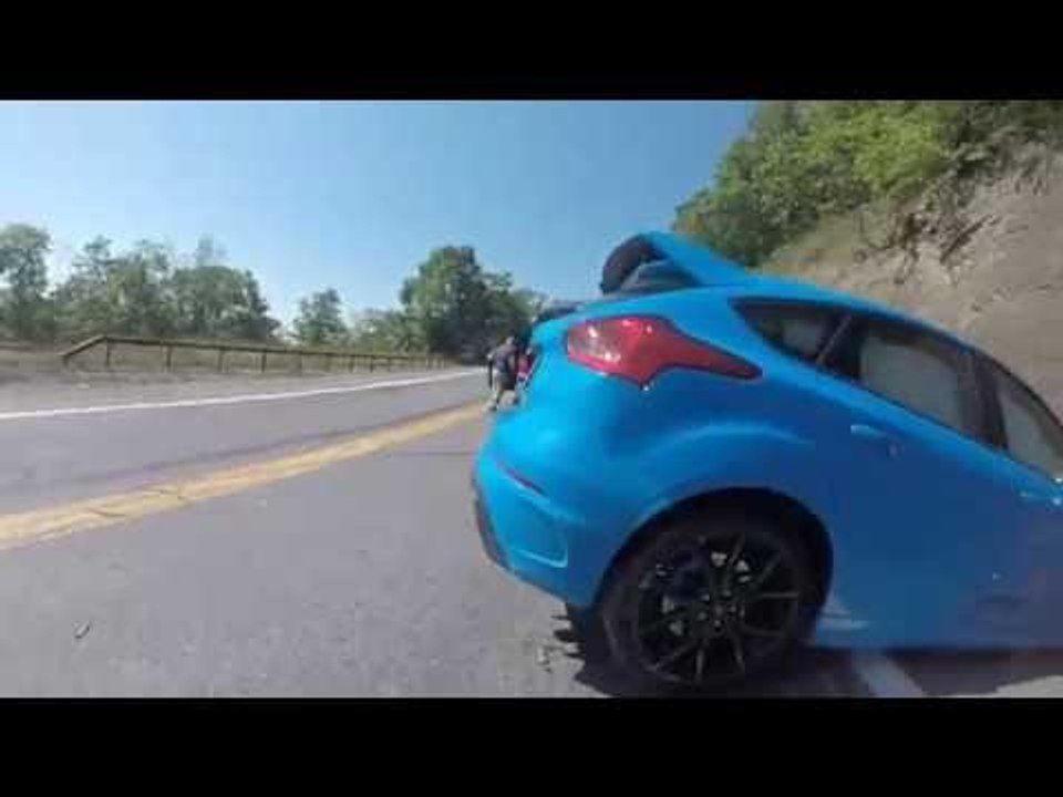 Car Attempting to Drift Around Hairpin Turn Crashes Into Wall