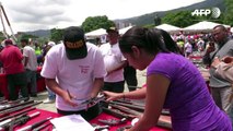 Venezuelans trade in guns for gadgets in state scheme