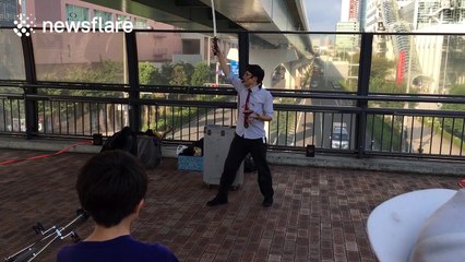 Man shows off impressive balance ability with Katana sword