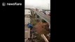 Abandoned bridge collapses, crushing construction vehicles