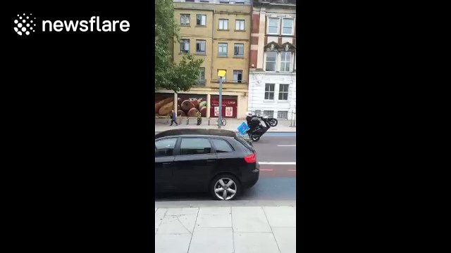 Domino's delivery driver topples off moped while performing wheelie