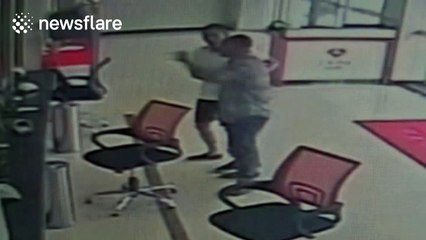 Man filmed trying to smash a bank door with a brick in China