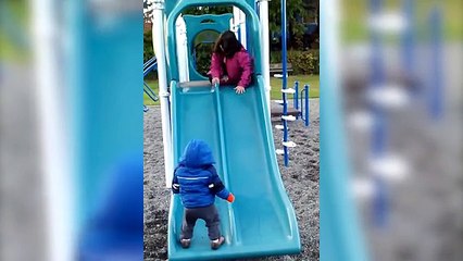 Funny Kid Takes Tumble Down Slide