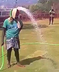 A Man watering a garden with his Head funny video must watch