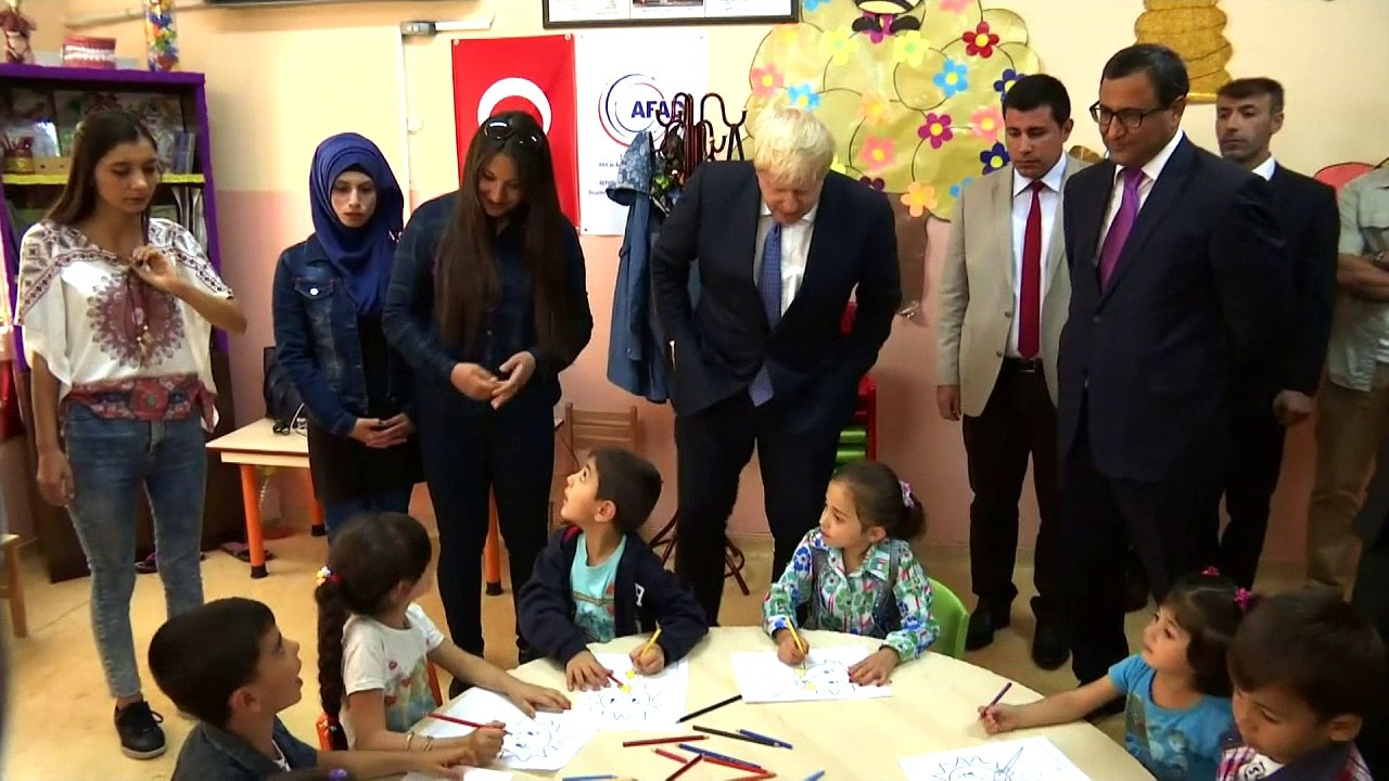 Bemused Boris serenaded on Turkish classroom visit