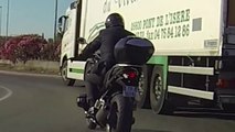 Ce motard prend tout les risques pour doubler un camion dans un rond point.... Gros débile