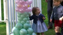 Prince George and Princess Charlotte play with balloons and pet animals