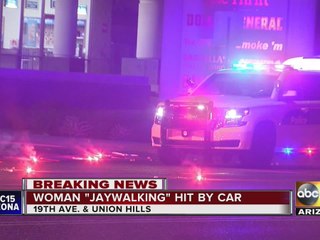 Woman jaywalking hit by car