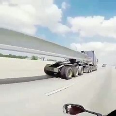 Biker crazy passes under serious truck