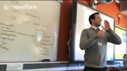 Teacher performs rap in front of class to mark National Poetry Day