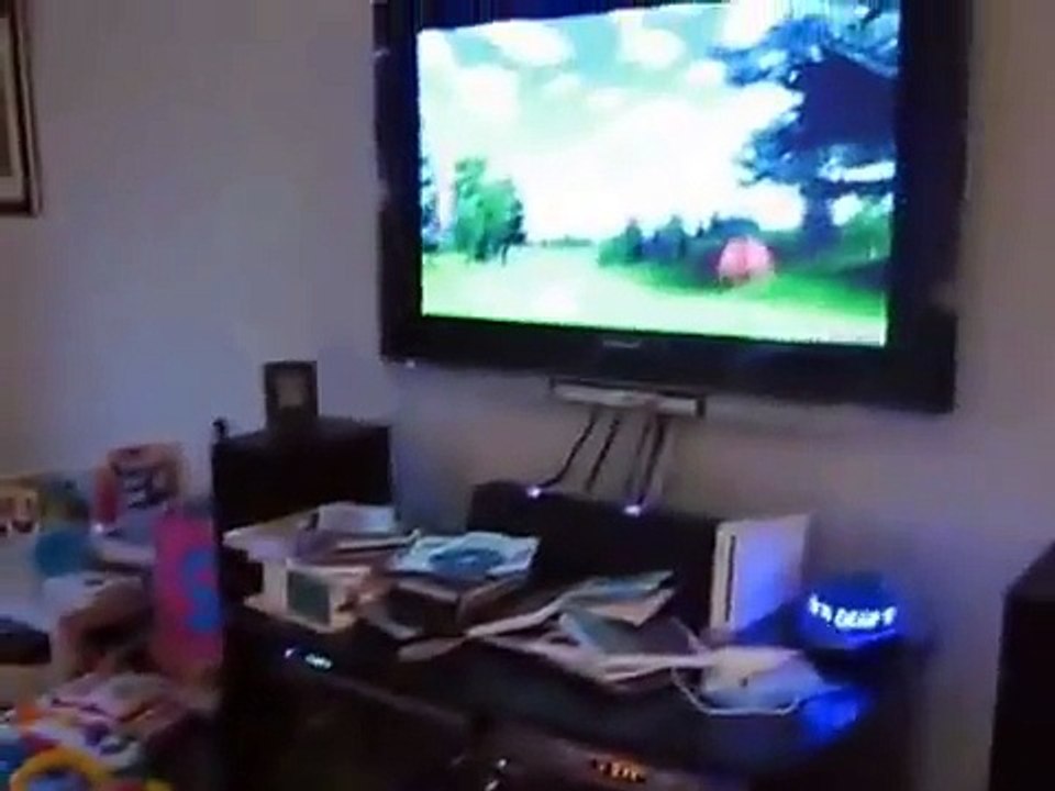 Un bébé éclate de rire pendant que son papa joue à la console