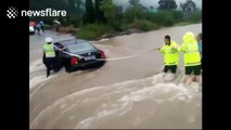 Police rescue three people from car trapped in floodwater