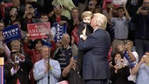 Trump brings young boy on stage, kisses him on the cheek