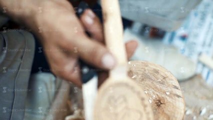 Woodcarver work in his workshop. Making wooden spoon with the knife