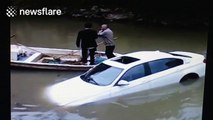 BMW ends up in river after driver presses accelerator by mistake
