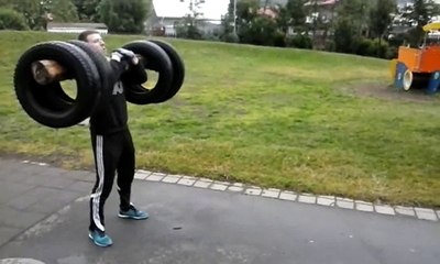 Icelandic Viking Erlingur Guðmundsson Squat farmer walk with log and tires