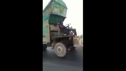 Only in Pakistan -  A Man drives a truck without truck's driver's cabin