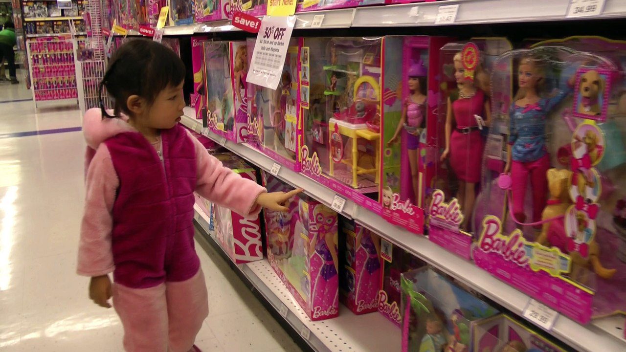 Girl Looking At Barbies