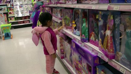 Girl Looking At Dolls