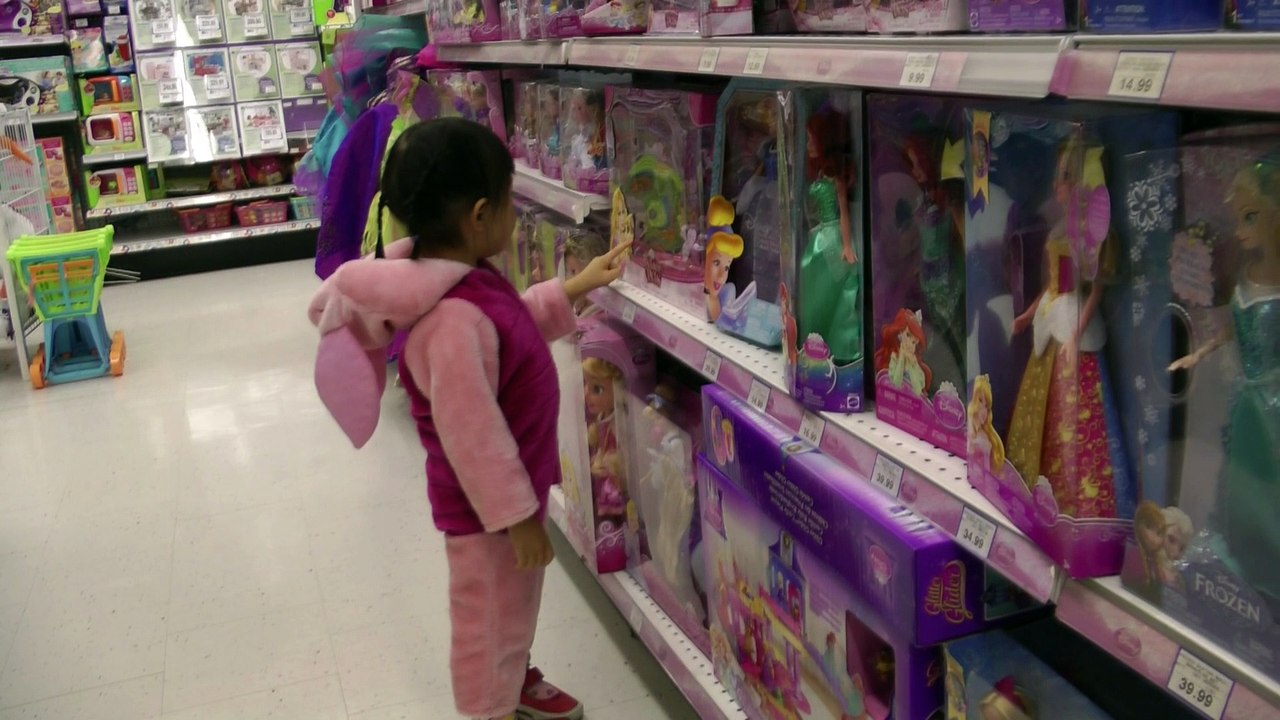 Girl Looking At Dolls