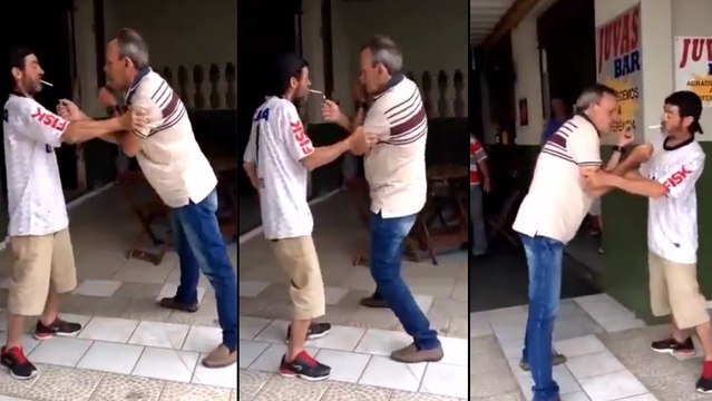 Ces deux mecs bourrés essayent d'allumer leurs cigarettes