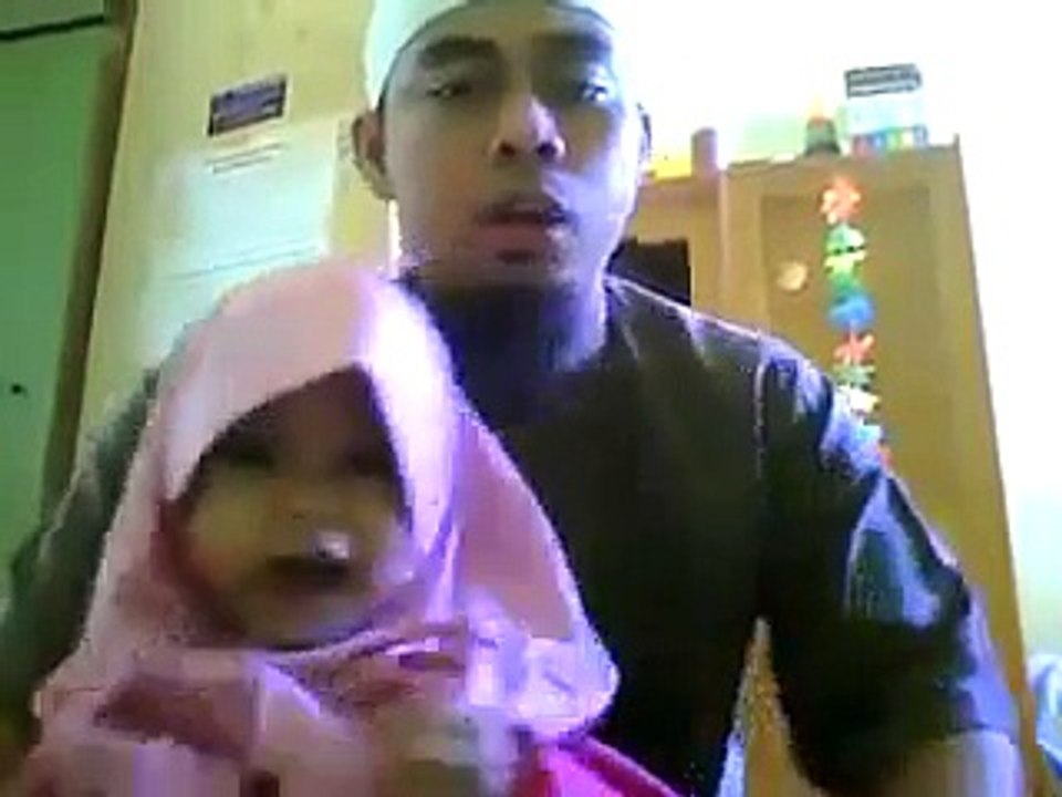 Father and daughter reciting Quran together