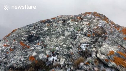 Strong winds on foggy mountain top