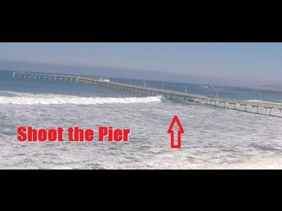 Daring Surfers Shoot the Ocean Beach Pier in San Diego During High Surf