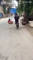 Father carrying two sons swinging on shoulder while riding bike