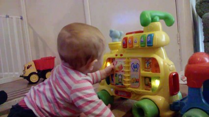 Cute baby playing with her toys at home and having lots of fun amusing herself