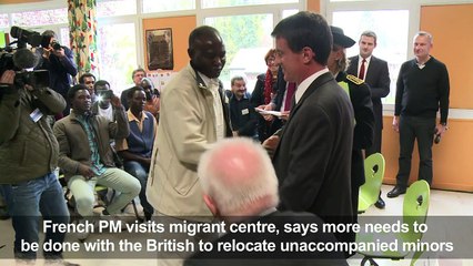 French PM visits migrant center, calls for UK action