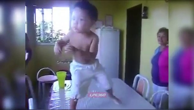 Funny Little Boy Dances On Table