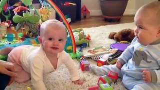 Cute babies interact with each other
