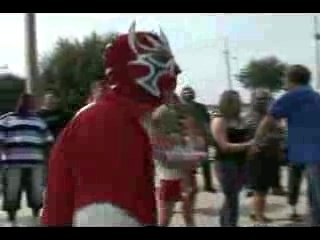 Hacksaw Jim Duggan attacks a Masked Guy