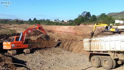 Doosan and hyundai excavator working with truck
