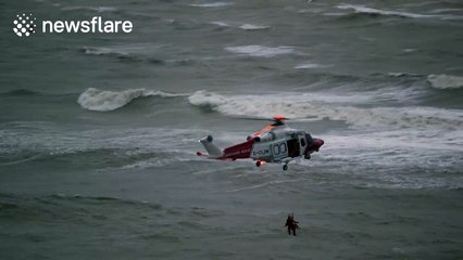 Woman dies after rescue helicopter winches her from sea during storm
