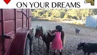 little girl try to ride pony